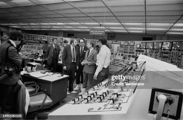 President Jimmy Carter listens as Professor Harold Benton , of the Nuclear Regulatory Commission, and a plant official brief him on the situation at...