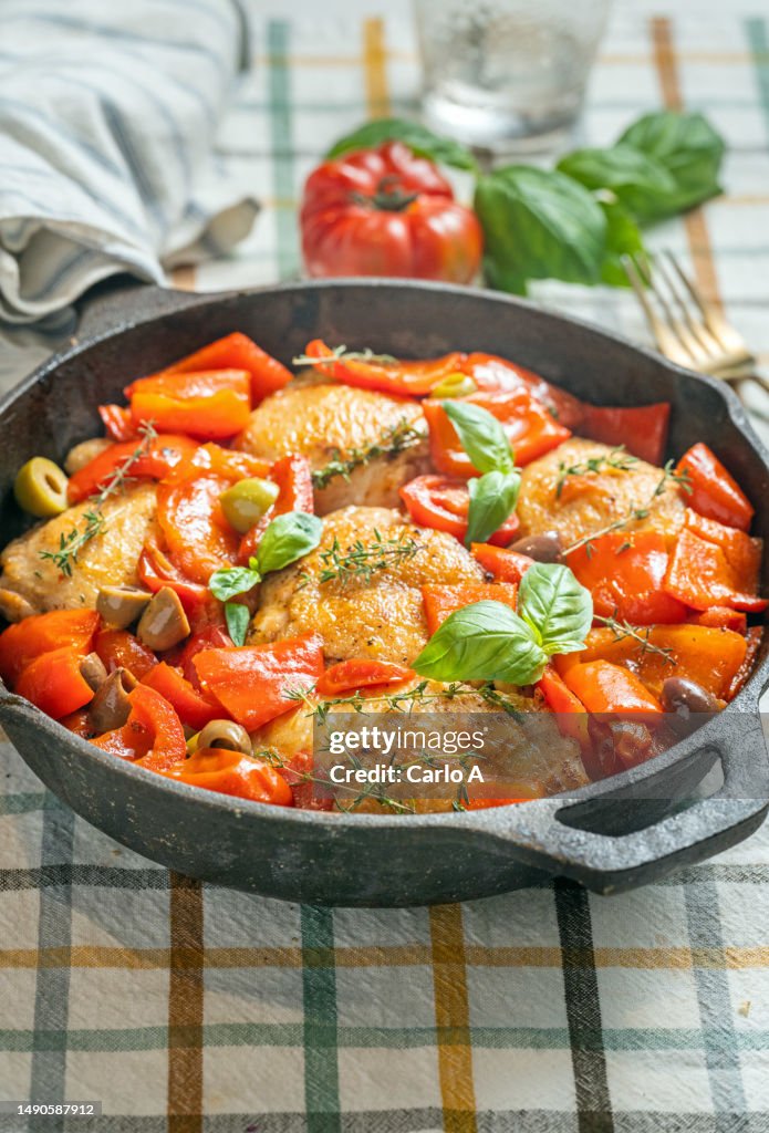 Braised chicken thighs in tomato and red bell peppers
