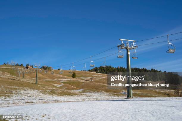 landscape shot of the cableway in passo tonale during autumn (italy, dolomiti di brenta). - ski hill stock pictures, royalty-free photos & images