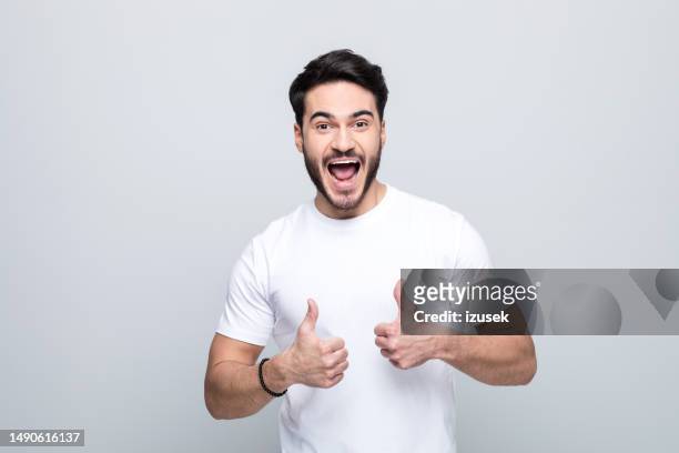 portrait of excited young man wuth thumbs up - teacher shouting stock pictures, royalty-free photos & images