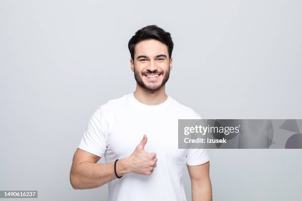 portrait of happy young man wuth thumb up - tummen upp bildbanksfoton och bilder