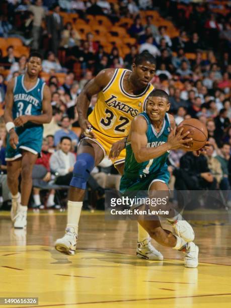 Muggsy Bogues, Point Guard for the Charlotte Hornets drives to the basket around Earvin "Magic" Johnson, Shooting Guard and Power Forward for the Los...