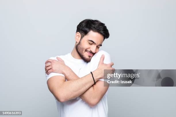 portrait of pleased young man - krama sig själv bildbanksfoton och bilder