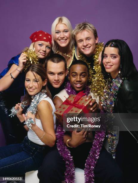 Festive themed studio portrait of the British pop group S Club 7 wearing tinsel, circa 2001. Clockwise from top left : Hannah Spearritt, Jo O'Meara,...