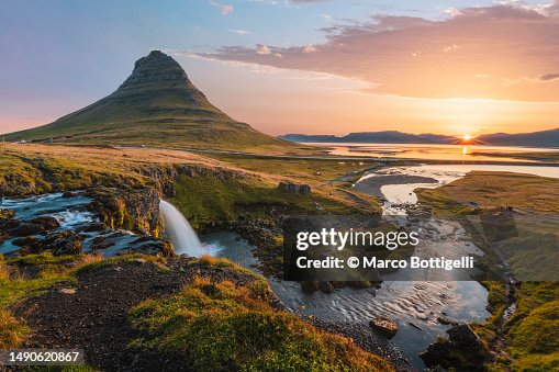 Mount Kirkjufell and Kirkjufellsfoss waterfall at sunrise, Iceland Mount Kirkjufell and Kirkjufellsfoss waterfall at sunrise, Iceland