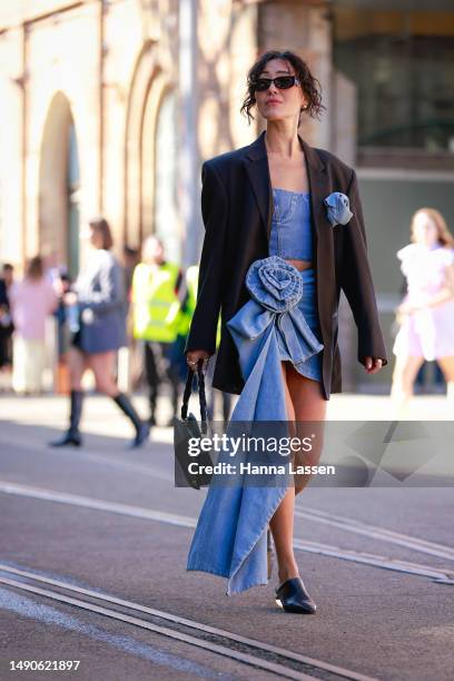Charlene Davies wearing Prada sunglasses, Jacquemus bag, Magdabutrym Denim crop top and mini skirt and Culturesse jewellery at Afterpay Australian...
