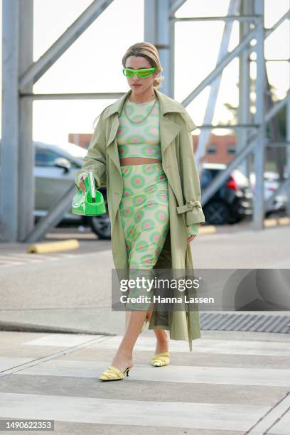Maxine Wylde wearing Sportmax two piece, khaki trench and neon green Fendi clutch at Afterpay Australian Fashion Week 2023 at Carriageworks on May...