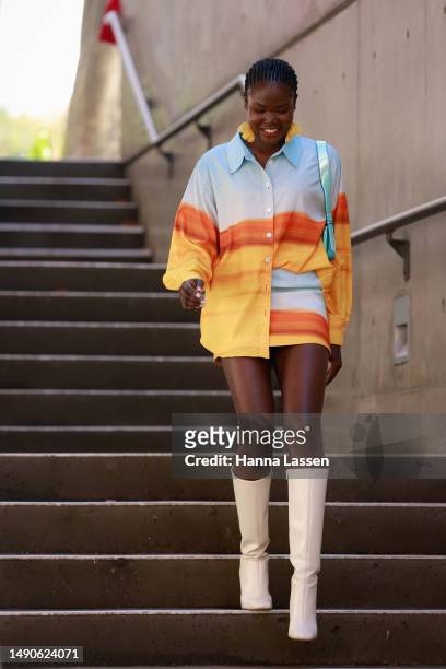 Malaan Ajang wearing C/MEO Collective shirt and skirt and white leather boots at Afterpay Australian Fashion Week 2023 at Carriageworks on May 16,...