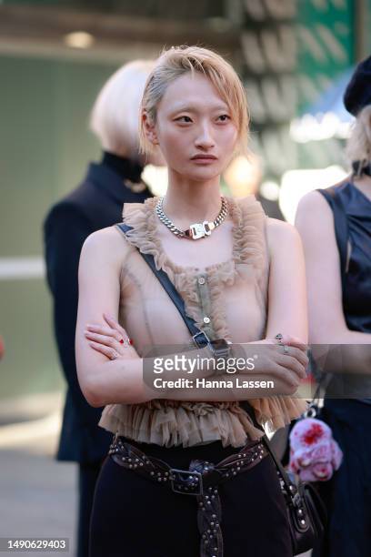 Guest wearing frill beige vest and bold gold necklace at Afterpay Australian Fashion Week 2023 at Carriageworks on May 16, 2023 in Sydney, Australia.