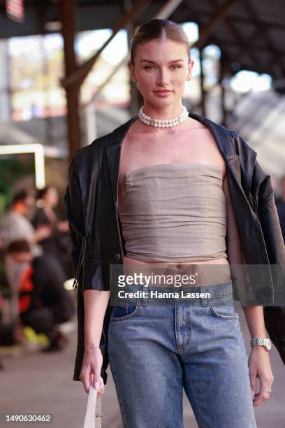 Amy Pejkovic wearing Magda Butrym denim, YSL bag at Afterpay Australian Fashion Week 2023 at Carriageworks on May 16, 2023 in Sydney, Australia.