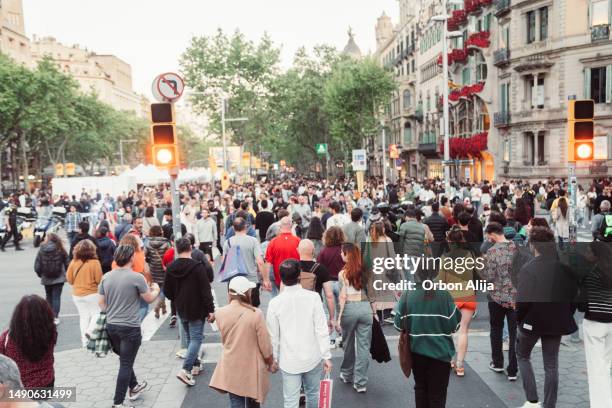 crowd of people walking at zebra crossing. - pedestrian stock pictures, royalty-free photos & images