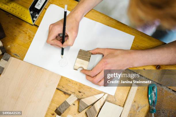 detail shot of two hands sketching an outline - drafter stock pictures, royalty-free photos & images
