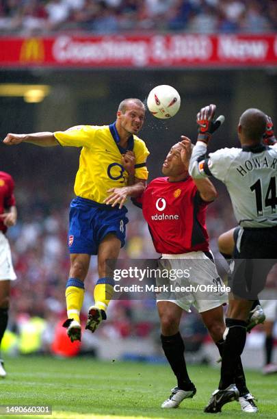 August 2003, Cardiff - FA Community Shield - Arsenal v Manchester United - Fredrik Ljungberg of Arsenal beats Michael Silvestre of Manchester United...