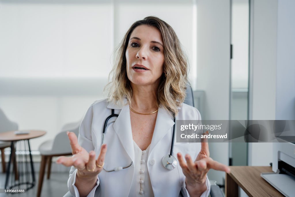 Portrait of a female doctor talking to the camera in online care