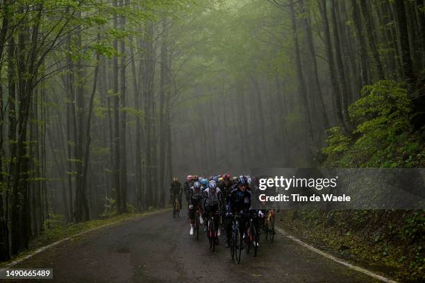General view of the peloton competing in heavy rain passing through a forest during the 106th Giro d'Italia 2023, Stage 10 a 196km stage from...