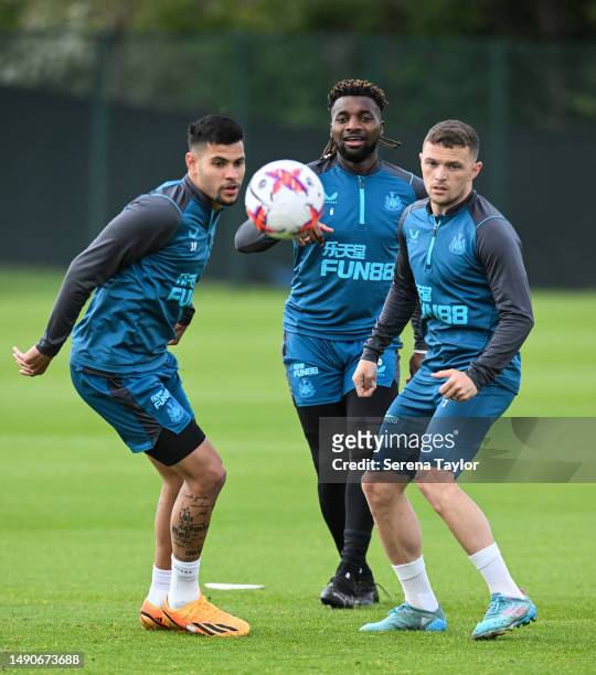 Allan Saint-Maximin passes the ball through Bruno Guimaraes and Kieran Trippier during the Newcastle United Training Session at the Newcastle United...