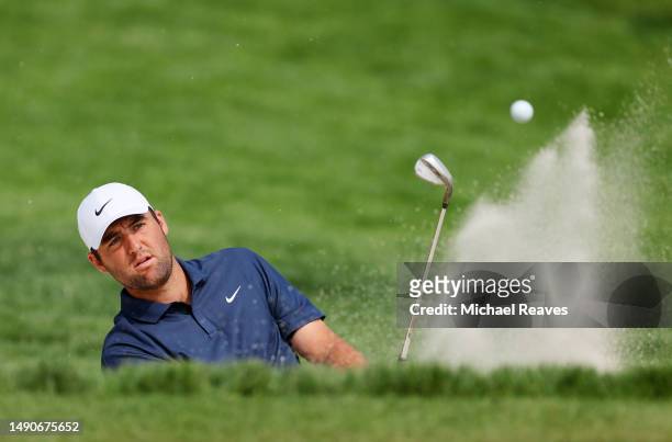 Scottie Scheffler of the United States plays a shot from a bunker on the 12th hole during a practice round prior to the 2023 PGA Championship at Oak...