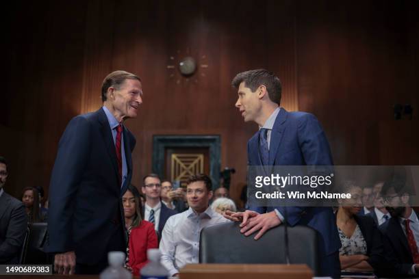 Samuel Altman, CEO of OpenAI, greets committee chairman Sen. Richard Blumenthal while arriving for testimony before the Senate Judiciary Subcommittee...