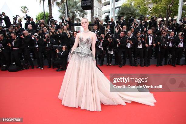 Elle Fanning attends the "Jeanne du Barry" Screening & opening ceremony red carpet at the 76th annual Cannes film festival at Palais des Festivals on...