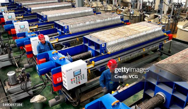 Employees recycle batteries from electric vehicles at a workshop of Paersen Environmental Technology Co., Ltd on May 16, 2023 in Weinan, Shaanxi...