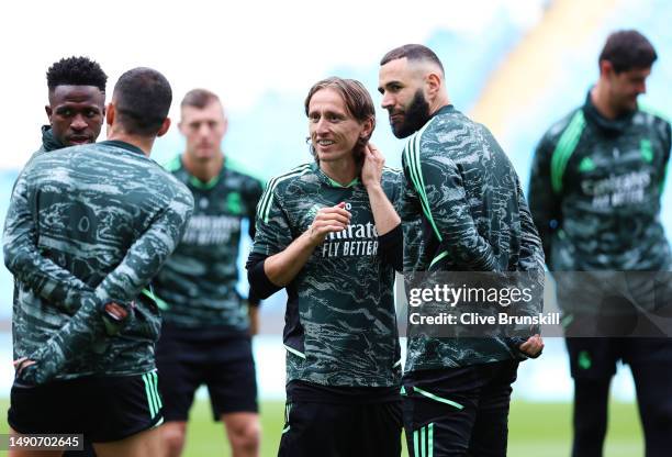 Luka Modric and Karim Benzema of Real Madrid chat as they take part in a training session ahead of their UEFA Champions League semi-final second leg...