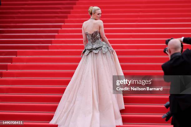 Elle Fanning attends the "Jeanne du Barry" Screening & opening ceremony red carpet at the 76th annual Cannes film festival at Palais des Festivals on...