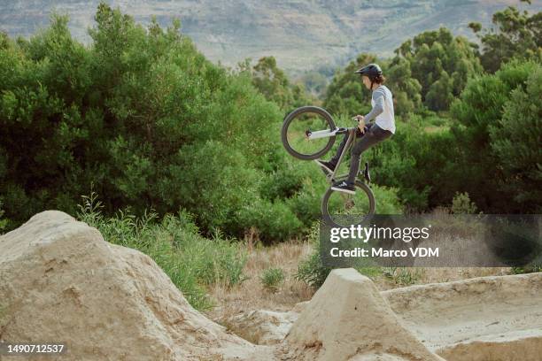 cycling jump, sports or mountain bike man with air trick for fun, exercise or training for speed travel race. dirt ramp, bicycle nature flight or extreme athlete with freestyle action - dirt bike stock pictures, royalty-free photos & images