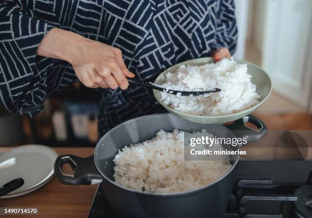 anonymous woman preparing rice at home - cooking stock pictures, royalty-free photos & images