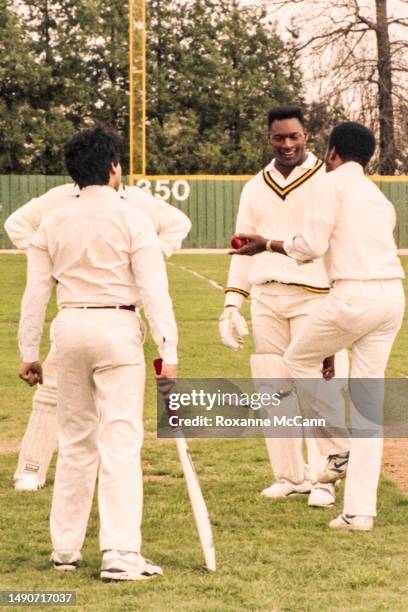 Award-winning professional baseball and football player Bo Jackson talks with cricket players while dressed in a cricket uniform in preparation for a...