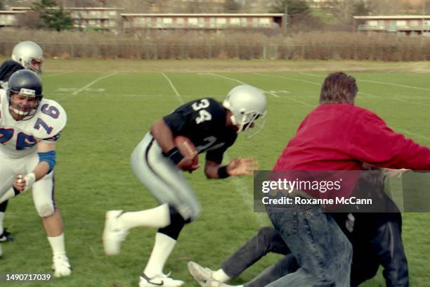 Award-winning professional baseball and football player Bo Jackson runs towards the camera crew wearing his NFL Los Angeles Raiders uniform and...