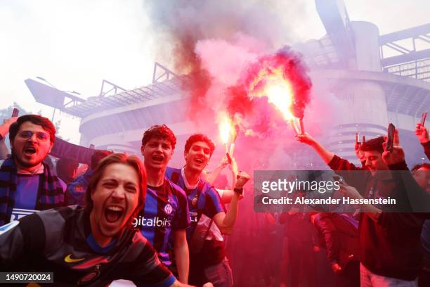 Internazionale fans show their support with flares as the team bus arrives prior to the UEFA Champions League semi-final second leg match between FC...