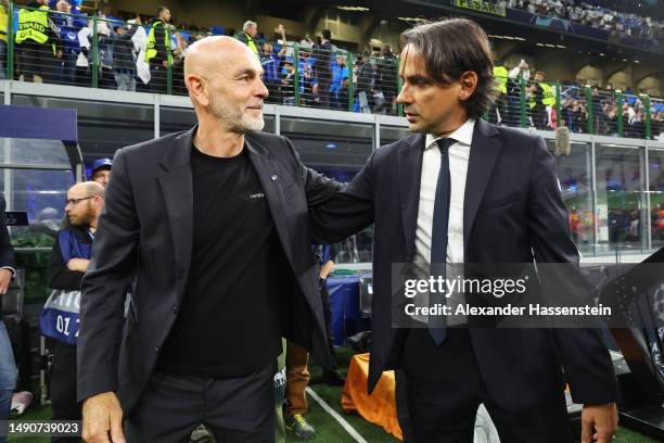 Stefano Pioli, Head Coach of AC Milan, talks to Simone Inzaghi, Head Coach of FC Internazionale, prior to the UEFA Champions League semi-final second...