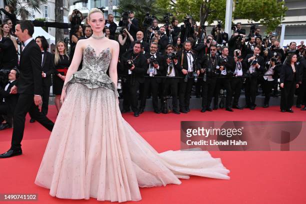 Elle Fanning attends the "Jeanne du Barry" screening & opening ceremony red carpet at the 76th Annual Cannes Film Festival at Palais des Festivals on...