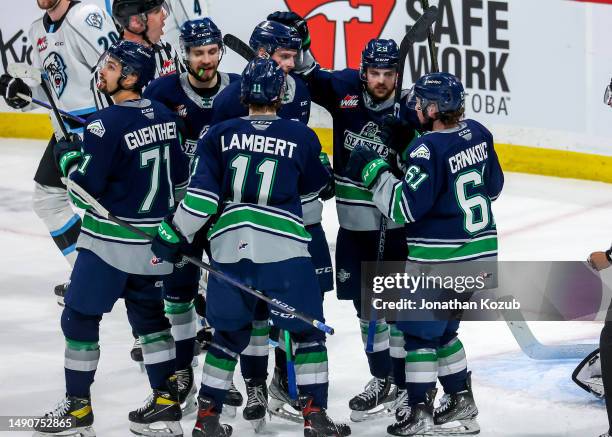 Dylan Guenther, Nolan Allan, Brad Lambert, Jared Davidson, and Kyle Crnkovic of the Seattle Thunderbirds congratulate teammate Kevin Korchinski...