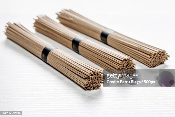 dried raw japanese soba noodle stick on white wooden background,romania - soba stock pictures, royalty-free photos & images