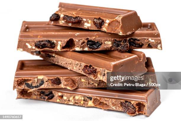 slices of milk chocolate with nuts and raisins,romania - milk chocolate stock pictures, royalty-free photos & images