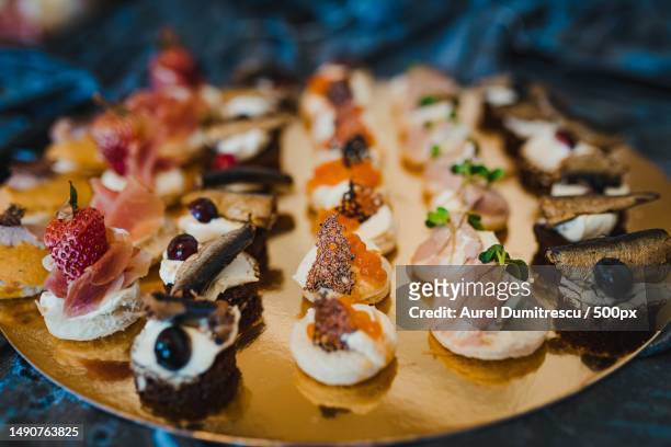 mix of luxury gourment canapes with herring,cream,fish eggs and prosciutto,romania - canape stock pictures, royalty-free photos & images