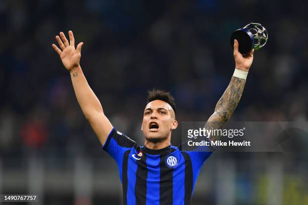 Lautaro Martinez of FC Internazionale celebrates the team's victory with the PlayStation Player of the Match award trophy after the final whistle of...