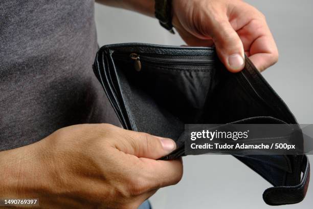 man looks at an empty purse without money there is no money crisis,romania - empty wallet stock pictures, royalty-free photos & images