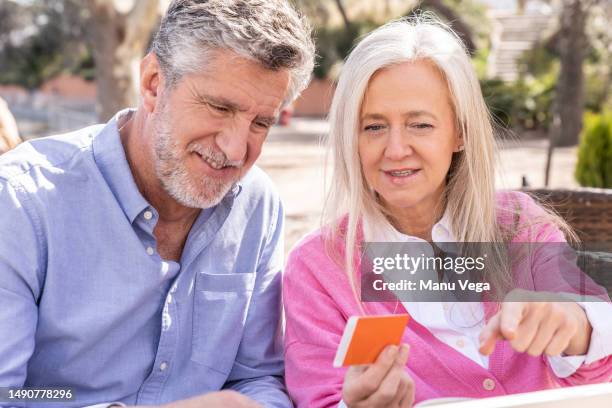 seniors sitting in a restaurant spending time together in the spring. - free wifi stock pictures, royalty-free photos & images