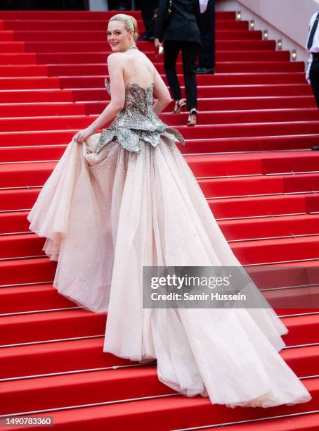 Elle Fanning attends the "Jeanne du Barry" Screening & opening ceremony red carpet at the 76th annual Cannes film festival at Palais des Festivals on...