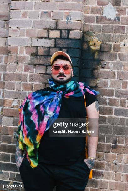 Guest wears Hugo Boss top, Versace bag, Johnny Big pants, Gucci glasses, Erik Yvon hat and Christian Louboutin boots at Afterpay Australian Fashion...