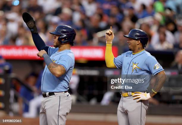 Harold Ramirez and Wander Franco of the Tampa Bay Rays signal to teammate Isaac Paredes that he hit a home run and not a double in the third inning...