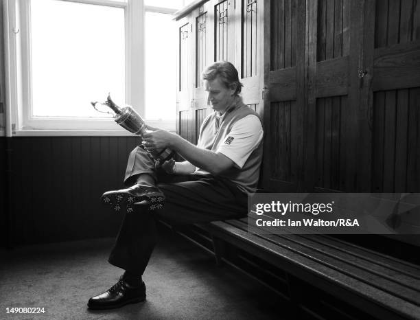 Ernie Els of South Africa poses with the Claret Jug in the locker room following his victory at the end of the final round of the 141st Open...