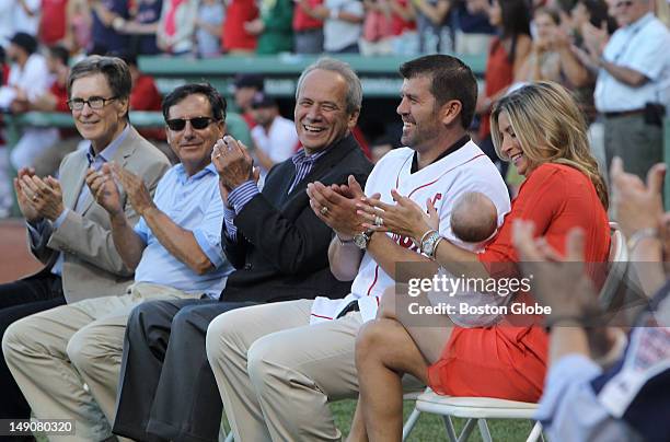 Boston Red Sox catcher Jason Varitek is honored for his career as a Red Sox accompanied by his wife and daughters during a pre-game ceremony.