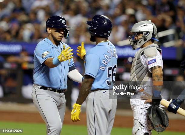 Isaac Paredes of the Tampa Bay Rays celebrates with Randy Arozarena after Paredes drove them both home with a home run in the fifth inning as...