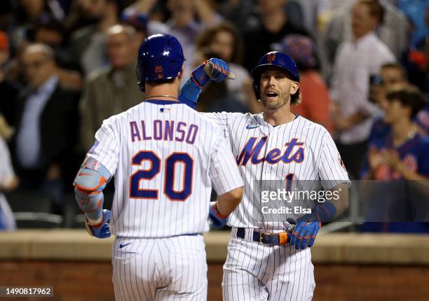 Jeff McNeil and Pete Alonso of the New York Mets celebrate after Alonso drove them both home with a two run home run in the seventh inning against...