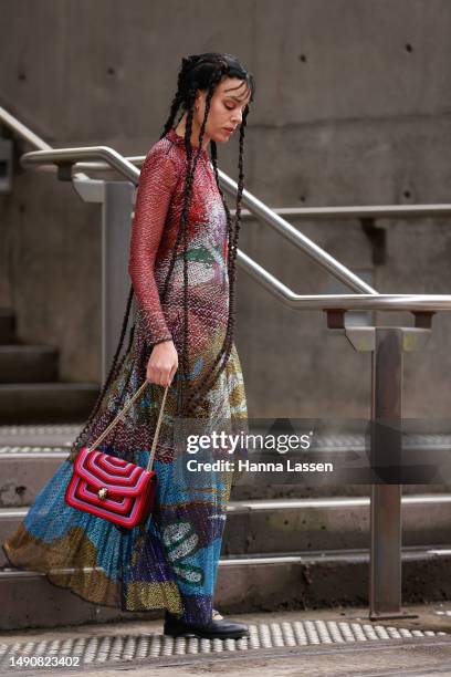 Fleur Egan wearing Armani maxi dress and black leather shoes, Bulgari pink bag at Afterpay Australian Fashion Week 2023 at Carriageworks on May 17,...