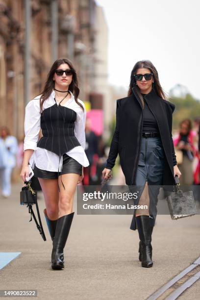 Guest wearing white shirt, black corset, black leather shorts and black leather boots at Afterpay Australian Fashion Week 2023 at Carriageworks on...