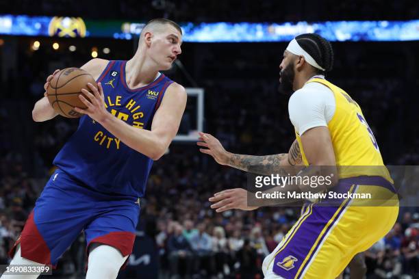 Nikola Jokic of the Denver Nuggets looks to pass the ball against Anthony Davis of the Los Angeles Lakers during the third quarter in game one of the...